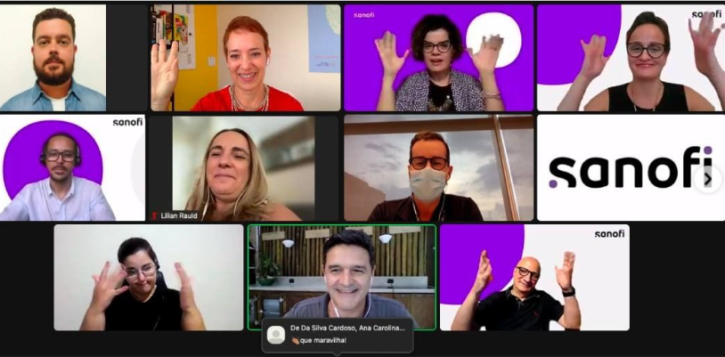 print de tela de reunião virtual com pessoas diversas participando e sorrindo
